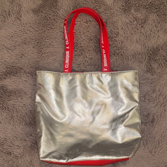 Clinique Handbags - Clinique Metallic Silver Tote with Red Handles Candy Cane Interior Shoulder Bag